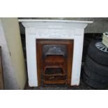 A cast iron fire surround with grate, 47 1/2" x 49 1/2" high x 7 1/2" deep.