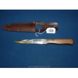 A WWII German fighting knife with leather scabbard, the blade marked 'hat 1942', blade sharpened.