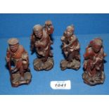 Four small hand carved wooden Oriental Figures, 4'' tall.