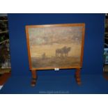 An Oak Art Deco style Firescreen framing an oil painting of horses pulling a plough, 17" x 14".