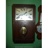 An Oak cased art deco design Wall Clock by Junghans having a rectangular face with Roman numerals