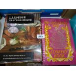 Two cookbooks:'Larousse Gatronomique' and 'The Constance Spry Cookery Book'.