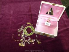 A musical jewellery box containing earrings, bracelets, necklaces etc.
