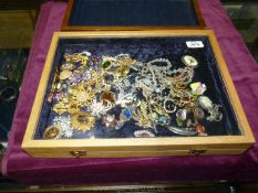 Two jewellery display cases and contents including glass bead necklaces, brooches, cufflinks etc.