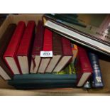 A box of books: Readers Digest novels and nature books.