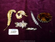 A selection of brooches including signed gold plated Miracle with Tortoiseshell setting,