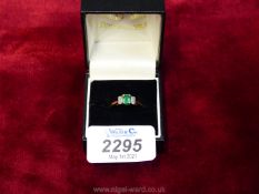 An 18ct. gold Emerald (.60 ct) and Diamond (.
