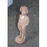 A concrete figure of a whistling boy, 25'' high.