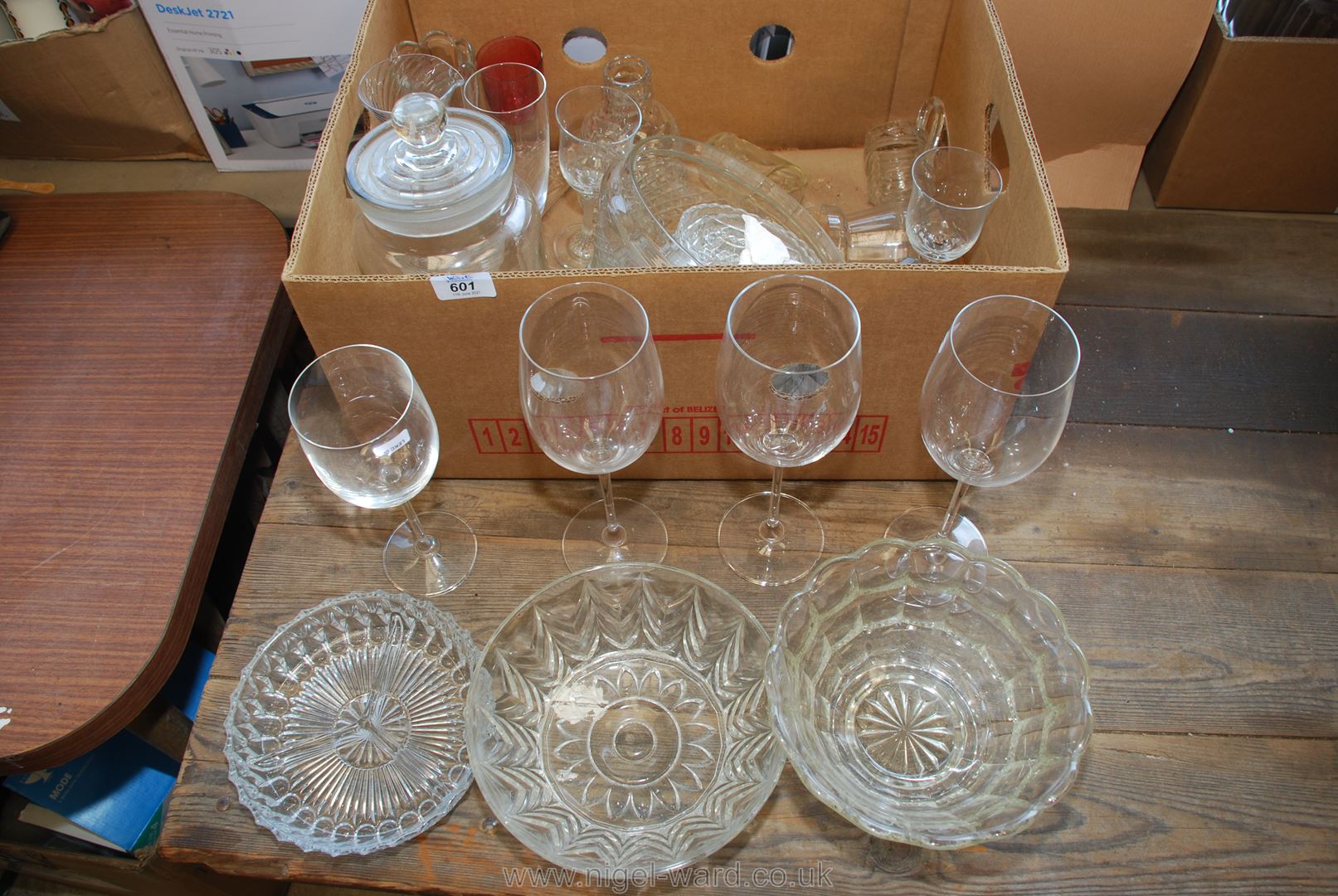 A box of miscellaneous glass, large wine glasses, trifle dish etc.