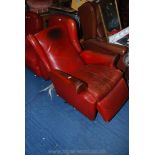 A leather effect wingback reclining chair.