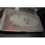 A small floral patterned fringed hearth rug. Approx 2' x 4'.