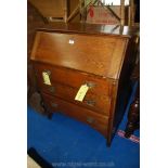 An oak, three drawer writing bureau.