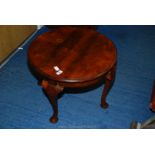 A circular hardwood occasional table.