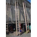 A sixteen rung single extension wooden Ladder.