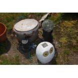 A lidded swing pot and three garden solar lights.