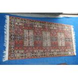 A small fringed rug with geometric pattern, 56" x 26".