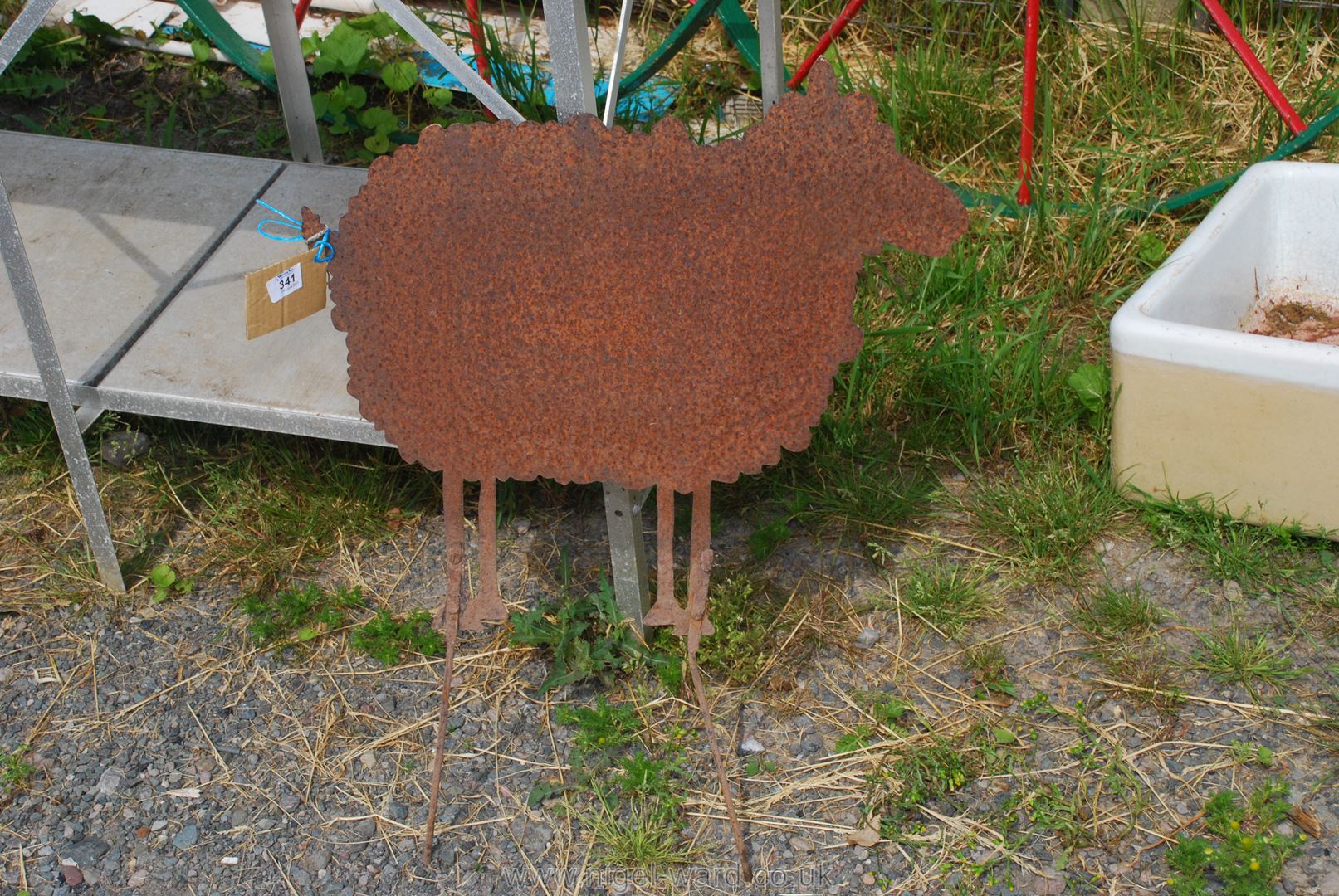 A metal sheep figure garden ornament.