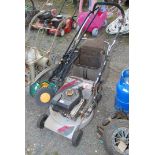 A petrol mower for repair and a push mower.