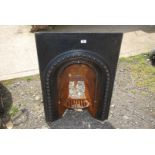 A cast and metal bedroom fire grate and surround, 24'' wide x 36 1/2'' high x 9'' deep.