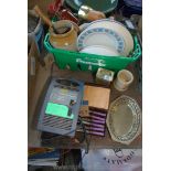 A basket of various plates, lights, china, butter knives and a car battery charger.