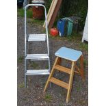 A wooden two stage kitchen steps and two step aluminium ladder.