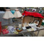 A box of table lamps, fabric/red satin sheets and miscellaneous ornaments.