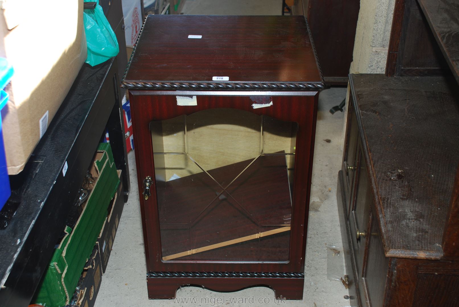 A darkwood glazed fronted music cabinet.