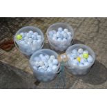 Four tubs of various Golf Balls.