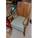 A caned back low Armchair with horizontal springs.
