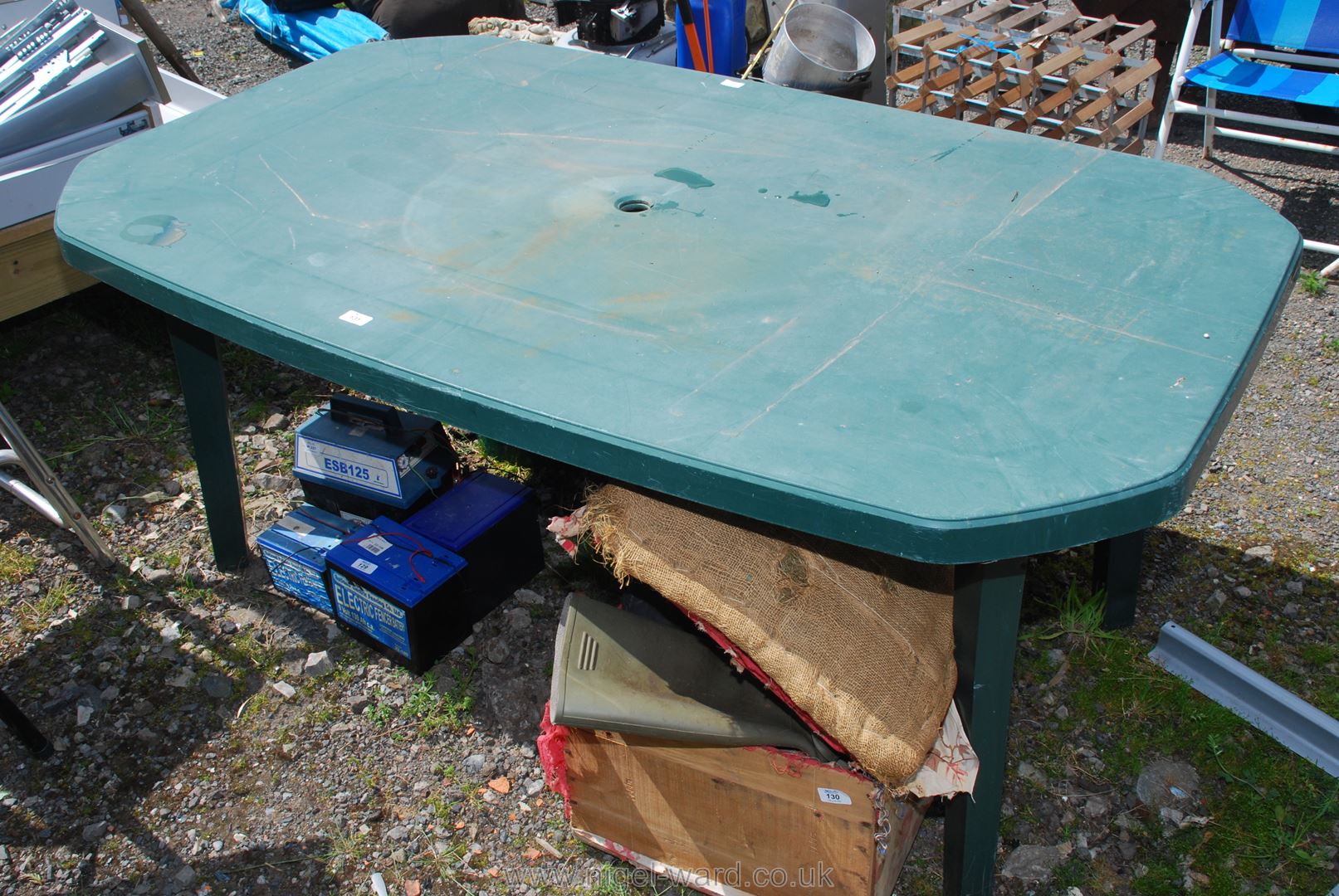 A green patio table, 64'' x 39''.