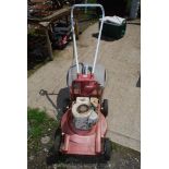 A Briggs & Stratton petrol Mower on aluminium body with grass collecting box.