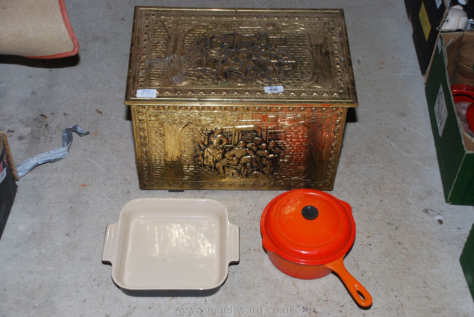 A Le Creuset 20 cm saucepan and lid, baking dish and brass coal box.