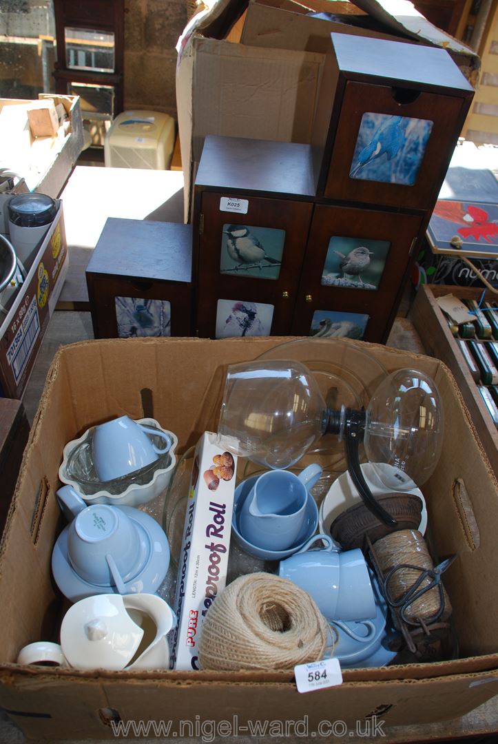 A box of part teaset, jelly moulds, coffee pot and wooden shelf unit.