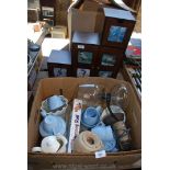 A box of part teaset, jelly moulds, coffee pot and wooden shelf unit.