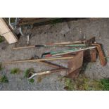 A quantity of garden rakes, hoes, shovels, etc.