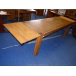 A modern hardwood removable drawer leaf dining table on four square legs,