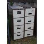 Two four drawer metal filing cabinets.