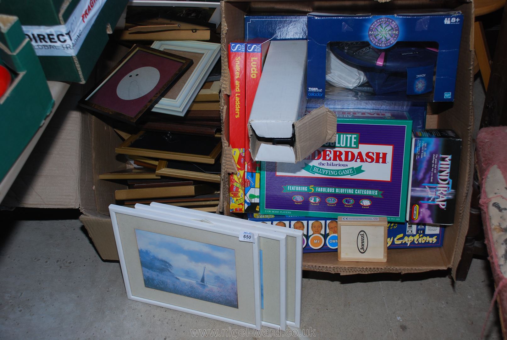 A box of miscellaneous games including 'Balderdash' and a box of picture frames.