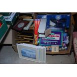 A box of miscellaneous games including 'Balderdash' and a box of picture frames.