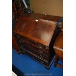 A four drawer writing bureau with fitted interior.