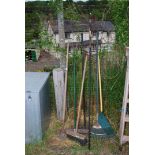 A quantity of garden rakes, broom, yard scraper, etc.