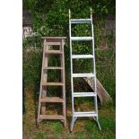 A convertible step ladder and five rung wooden steps.