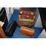 A quantity of suitcases, briefcases etc.