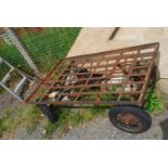 A metal framed four wheel Trolley on solid tyres, 48'' x 32''.