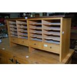 A wooden stationery unit with four lower drawers.