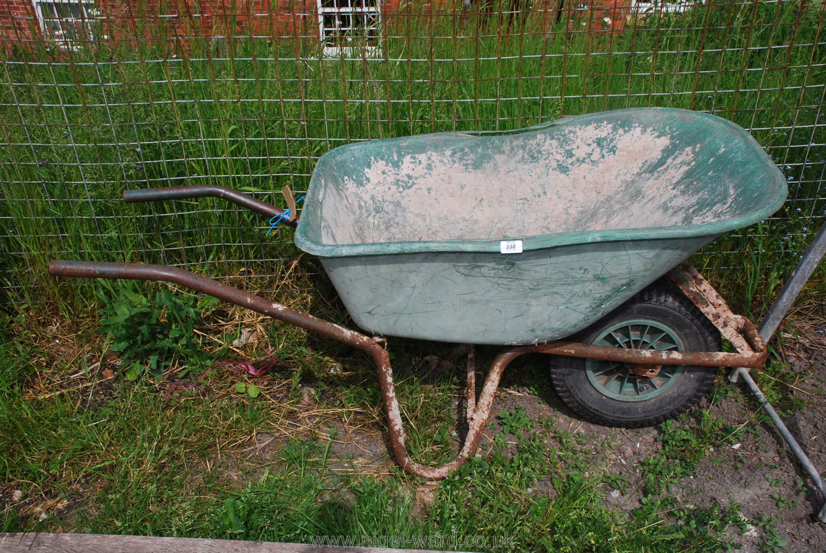 A plastic builder's Barrow with pneumatic tyre.