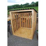 A wooden slatted log store.