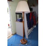 A turned wood standard lamp with shade.