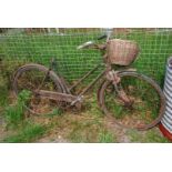 A 'barn-find' ladies Hercules bike with front wicker basket for restoration.