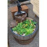 A wooden 1/2 barrow garden planter with feature.